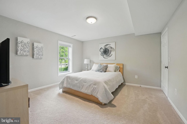 carpeted bedroom with baseboards