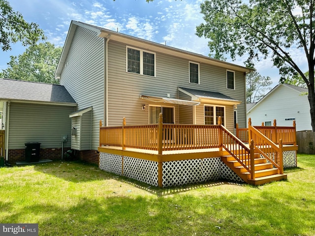 rear view of house featuring a yard and a wooden deck
