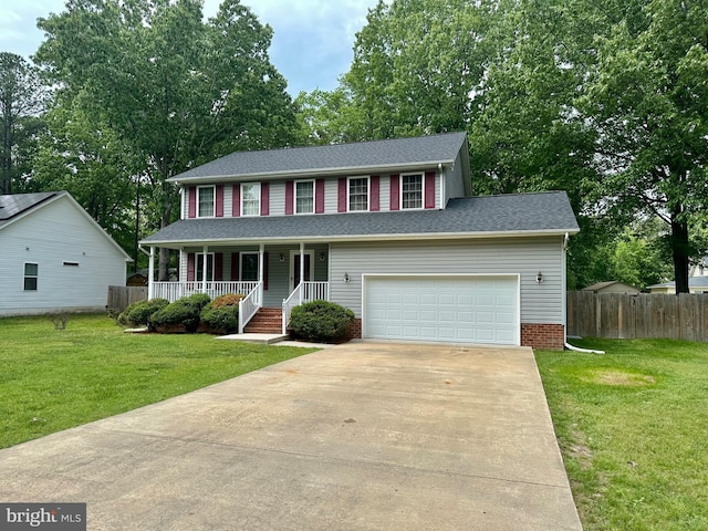 view of front of house with fence, a porch, driveway, and a front yard
