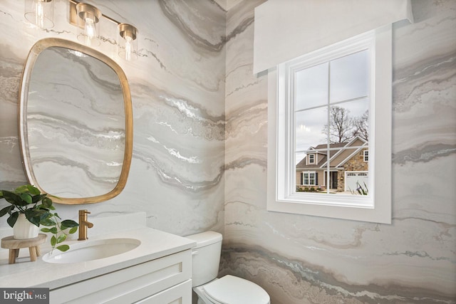 bathroom featuring vanity and toilet