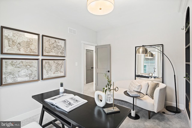 carpeted office with baseboards and visible vents