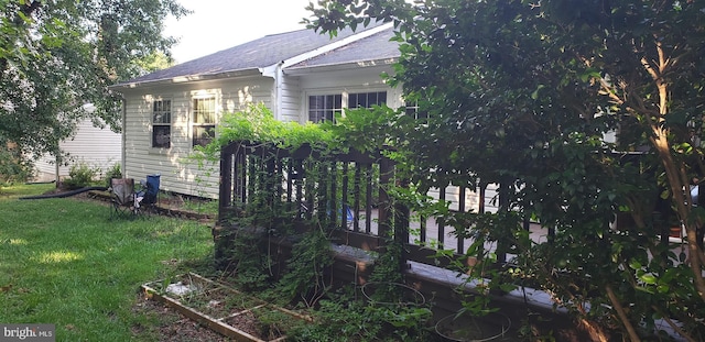 view of side of home featuring a yard and a garden