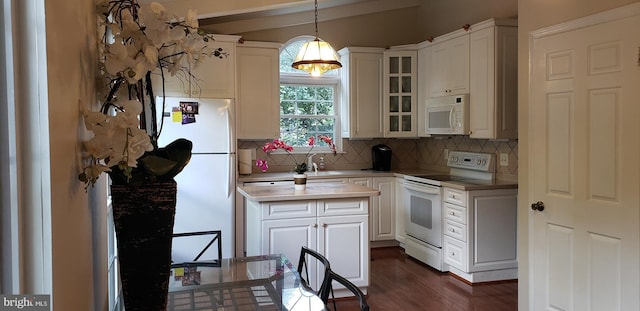 kitchen with tasteful backsplash, light countertops, dark wood-style floors, glass insert cabinets, and white appliances
