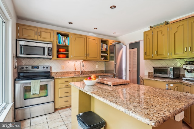2409 Hayden Dr, Silver Spring, MD 20902 - kitchen featuring stainless steel appliances, open shelves, backsplash, a kitchen island, and light stone countertops