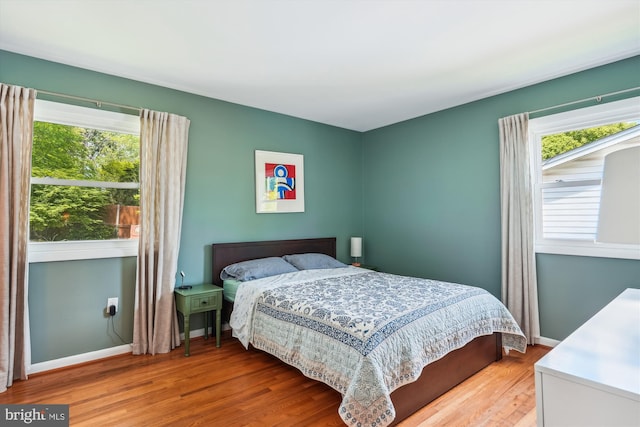 2409 Hayden Dr, Silver Spring, MD 20902 - bedroom with multiple windows, wood finished floors, and baseboards