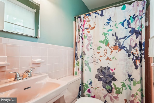 2409 Hayden Dr, Silver Spring, MD 20902 - full bathroom featuring a sink, toilet, tile walls, and a shower with shower curtain