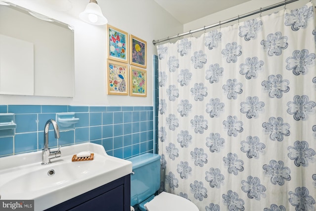 2409 Hayden Dr, Silver Spring, MD 20902 - full bathroom with toilet, vanity, tile walls, a shower with shower curtain, and wainscoting