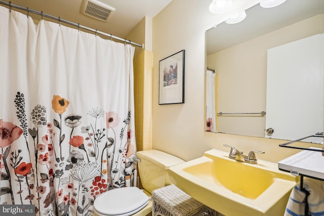 2409 Hayden Dr, Silver Spring, MD 20902 - bathroom with a sink, toilet, and a shower with shower curtain