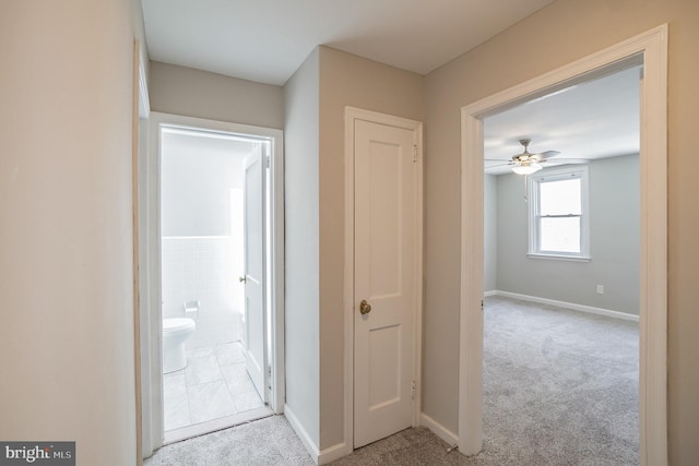 corridor with carpet floors and baseboards