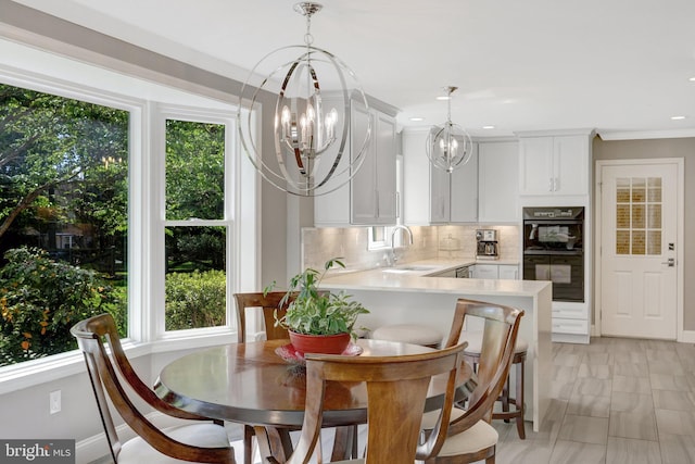 dining area featuring recessed lighting, baseboards, marble finish floor, a chandelier, and crown molding