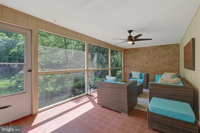 sunroom with a wealth of natural light, ceiling fan, and an outdoor living space