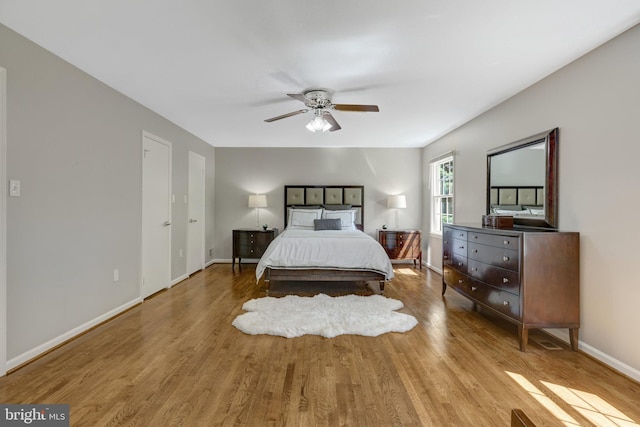 bedroom featuring baseboards, ceiling fan, and wood finished floors