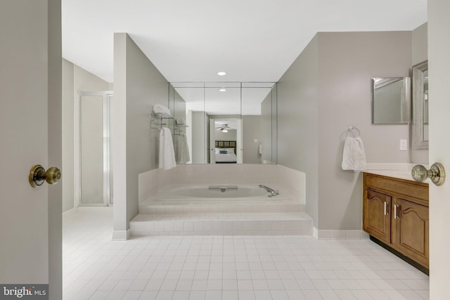 full bathroom featuring a stall shower, ceiling fan, tile patterned flooring, a garden tub, and vanity