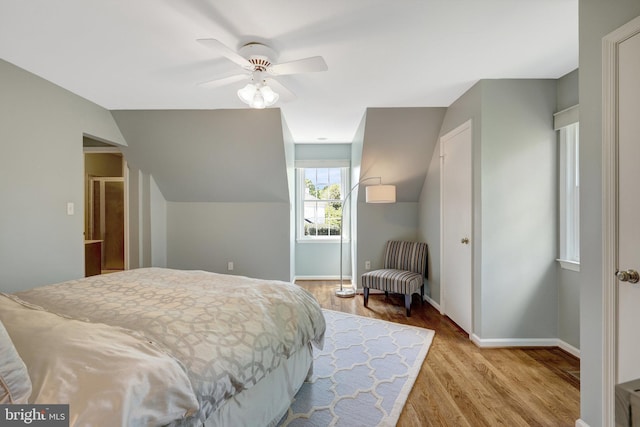 bedroom with a ceiling fan, wood finished floors, and baseboards