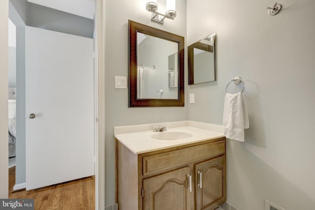 bathroom with vanity and wood finished floors