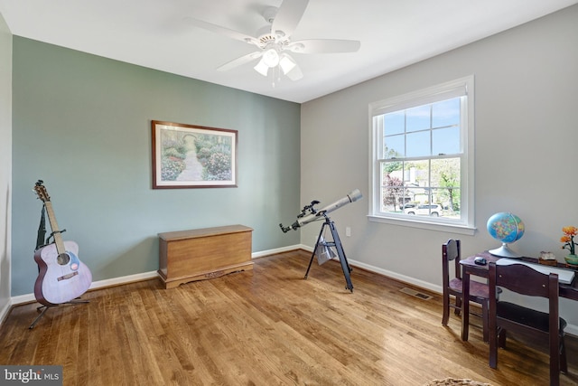 miscellaneous room featuring ceiling fan, baseboards, visible vents, and wood finished floors
