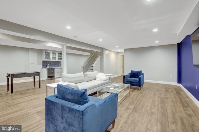 living area featuring wine cooler, recessed lighting, baseboards, stairs, and light wood-style floors