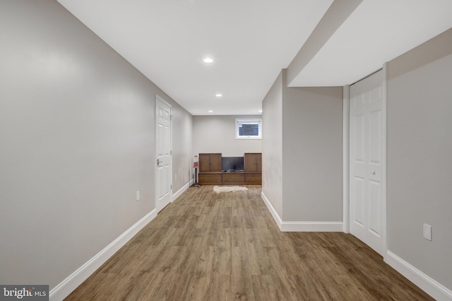 hall with baseboards, recessed lighting, and wood finished floors