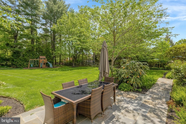 view of patio / terrace with a playground and outdoor dining space