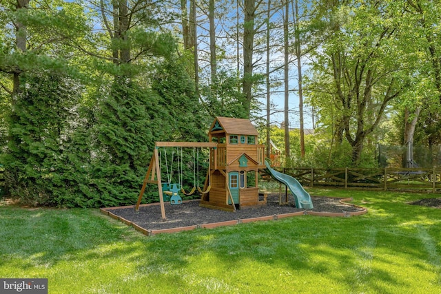 view of play area with fence and a lawn