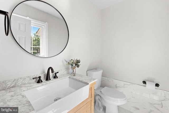 half bathroom with toilet and vanity