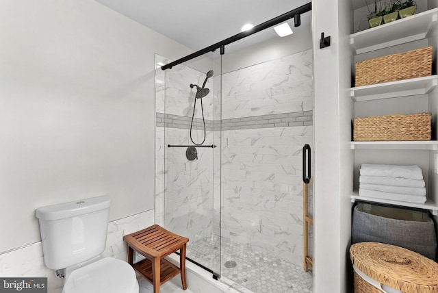 full bath with toilet and a stall shower