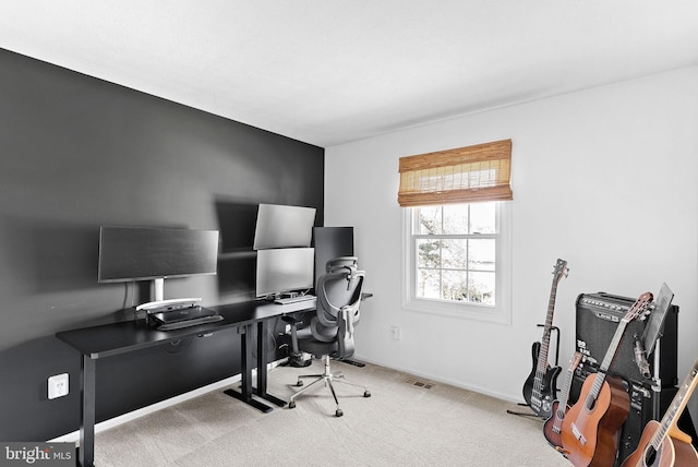 carpeted home office featuring baseboards and visible vents