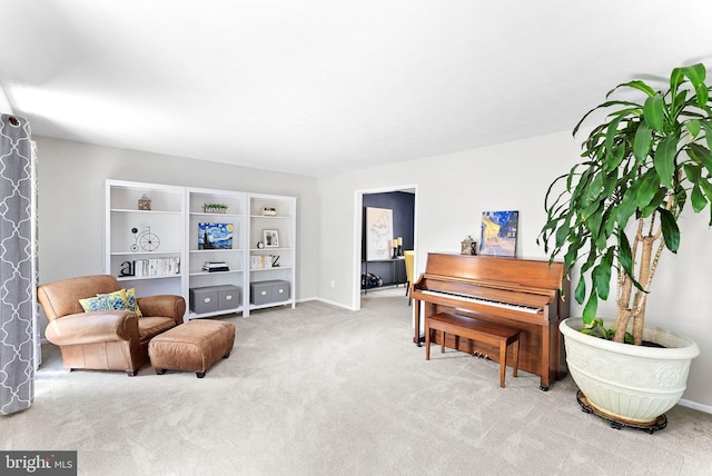 sitting room featuring baseboards and carpet