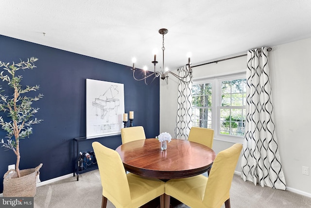 dining area with baseboards, carpet flooring, and a chandelier