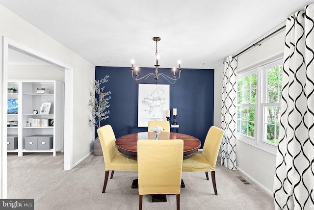 dining area featuring carpet floors, a chandelier, baseboards, and visible vents