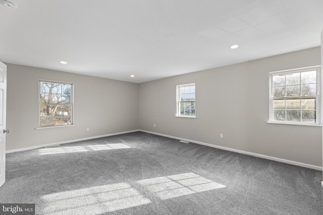 carpeted empty room with baseboards and recessed lighting