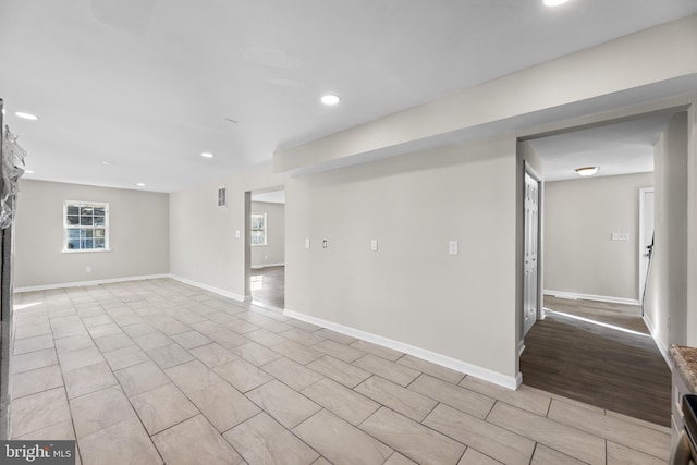 empty room with recessed lighting and baseboards