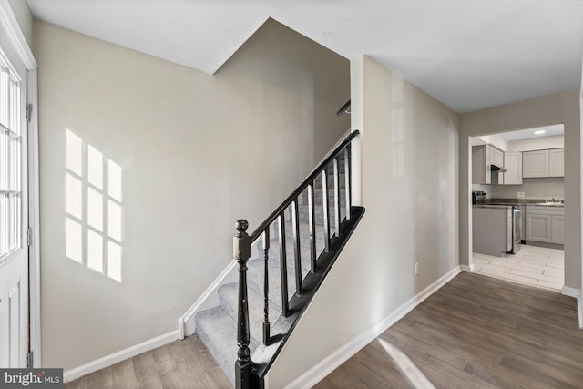 stairs featuring baseboards and wood finished floors