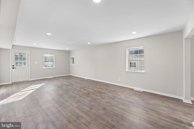 below grade area featuring wood finished floors, baseboards, and recessed lighting
