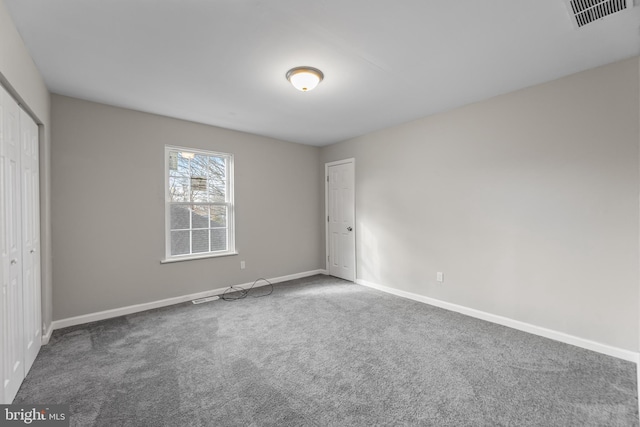 unfurnished bedroom with carpet, baseboards, and a closet