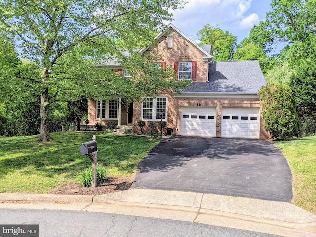 view of front of house with a shingled roof, brick siding, a garage, aphalt driveway, and a front yard