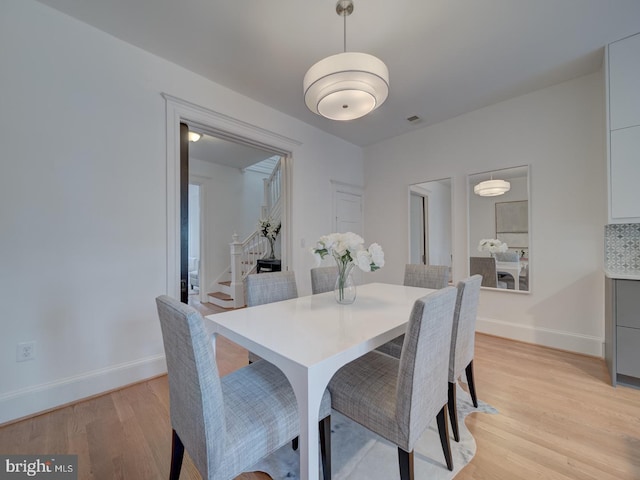 27 Seaton Pl NW, Washington, DC 20001 - dining room featuring stairway, baseboards, light wood-style flooring, and visible vents