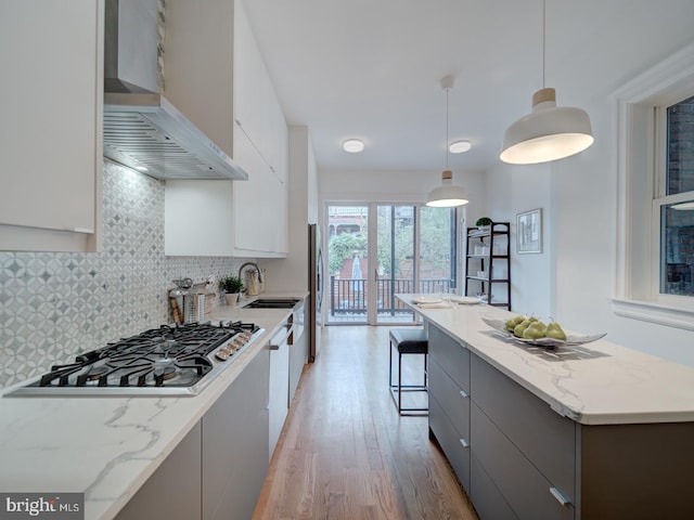 27 Seaton Pl NW, Washington, DC 20001 - kitchen featuring gray cabinetry, modern cabinets, stainless steel appliances, and wall chimney exhaust hood