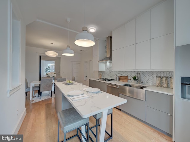 27 Seaton Pl NW, Washington, DC 20001 - kitchen with a sink, wall chimney exhaust hood, decorative backsplash, a kitchen island, and modern cabinets