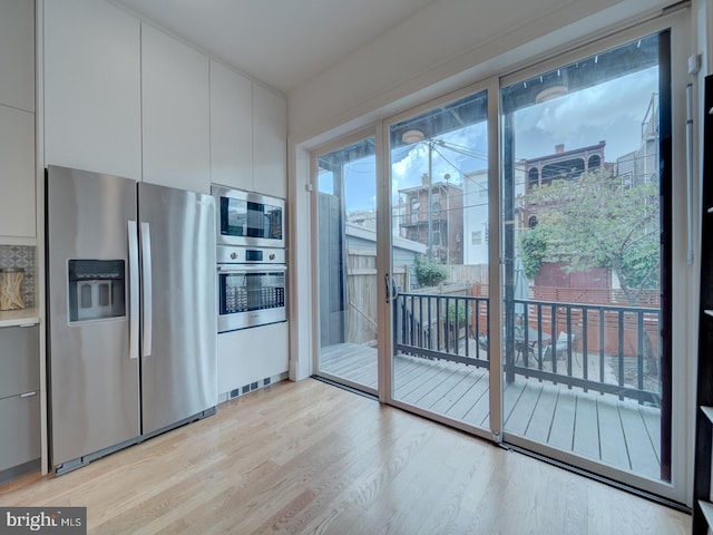 27 Seaton Pl NW, Washington, DC 20001 - kitchen featuring appliances with stainless steel finishes, white cabinets, modern cabinets, and light wood finished floors