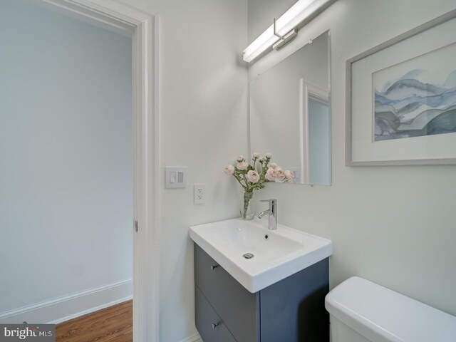 27 Seaton Pl NW, Washington, DC 20001 - bathroom with toilet, baseboards, wood finished floors, and vanity