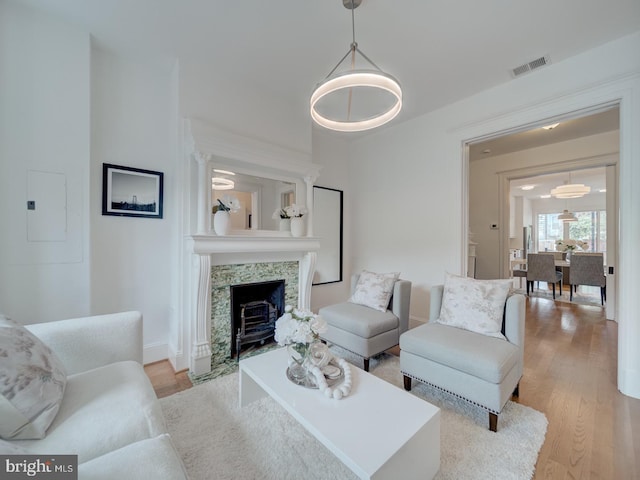 27 Seaton Pl NW, Washington, DC 20001 - living room featuring baseboards, wood finished floors, a tile fireplace, visible vents, and electric panel