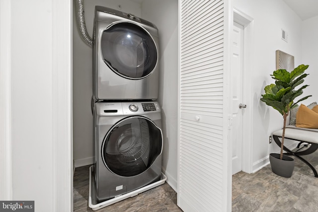1818 N Front St Unit B, Philadelphia, PA 19122 - laundry room featuring laundry area, stacked washing maching and dryer, and baseboards