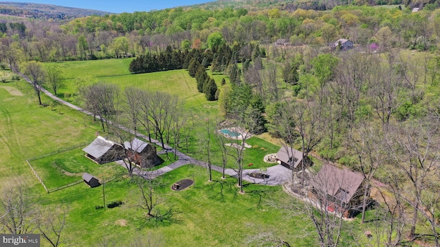 birds eye view of property with a view of trees and a rural view