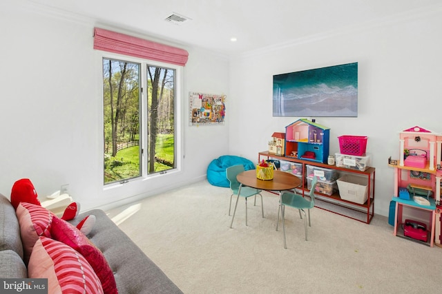 rec room with visible vents, carpet, crown molding, and baseboards