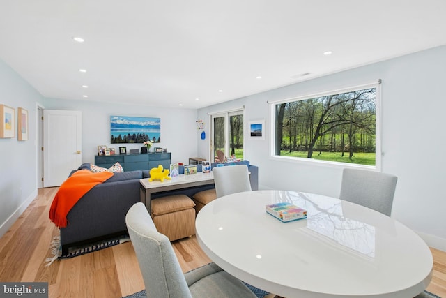 dining room featuring recessed lighting, baseboards, and light wood-style floors