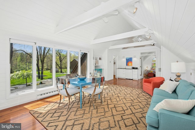 sunroom / solarium with beamed ceiling and a baseboard radiator