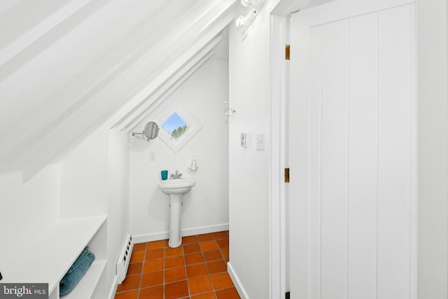 bathroom featuring baseboards, tile patterned flooring, and a baseboard heating unit