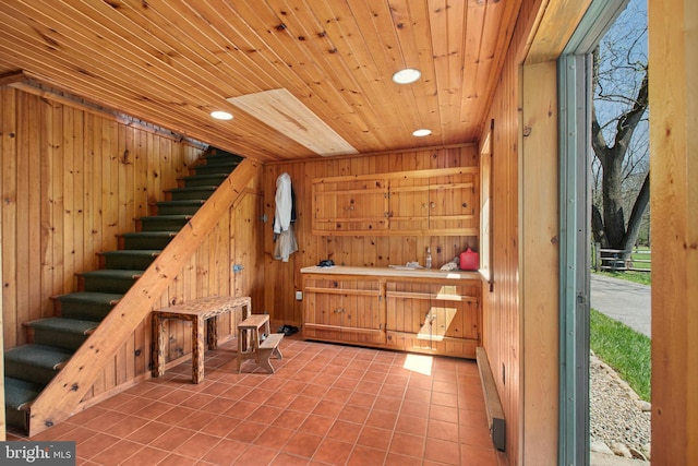 interior space featuring recessed lighting, tile patterned floors, wood walls, and wooden ceiling