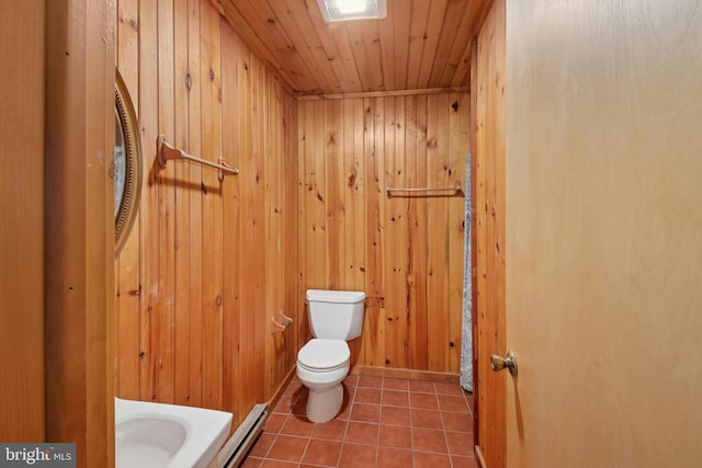 bathroom with toilet, tile patterned floors, wood walls, wooden ceiling, and a baseboard radiator